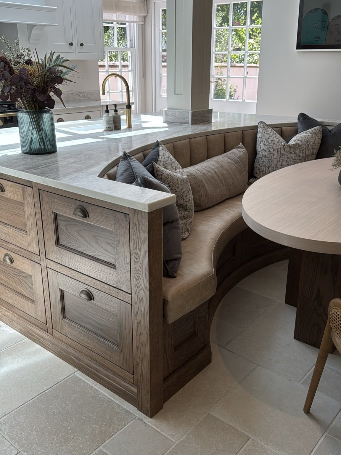 15 Ranch Style House Kitchen Remodel Ideas, Retro to Modern 10 Curved built-in dining nook with tan seating and a round wooden table.