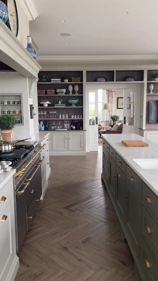 15 Ranch Style House Kitchen Remodel Ideas, Retro to Modern 3 Dark green kitchen island with white countertop in a bright, modern ranch kitchen.