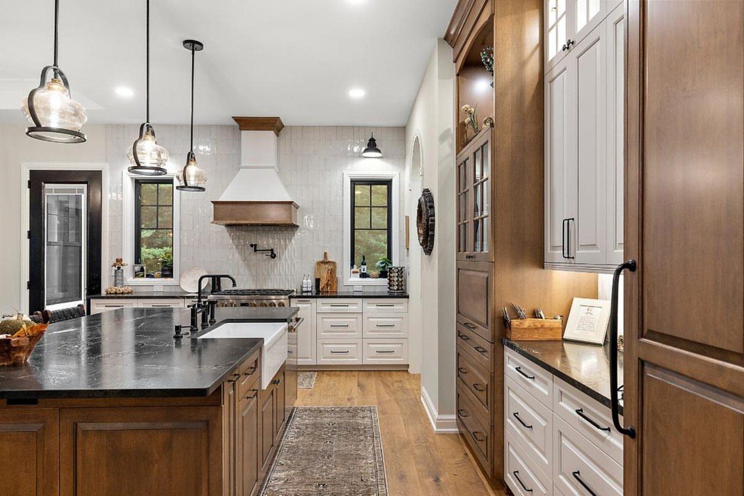 15 Ranch Style House Kitchen Remodel Ideas, Retro to Modern 11 Kitchen with two-tone cabinetry featuring white lower cabinets and natural wood upper cabinets.