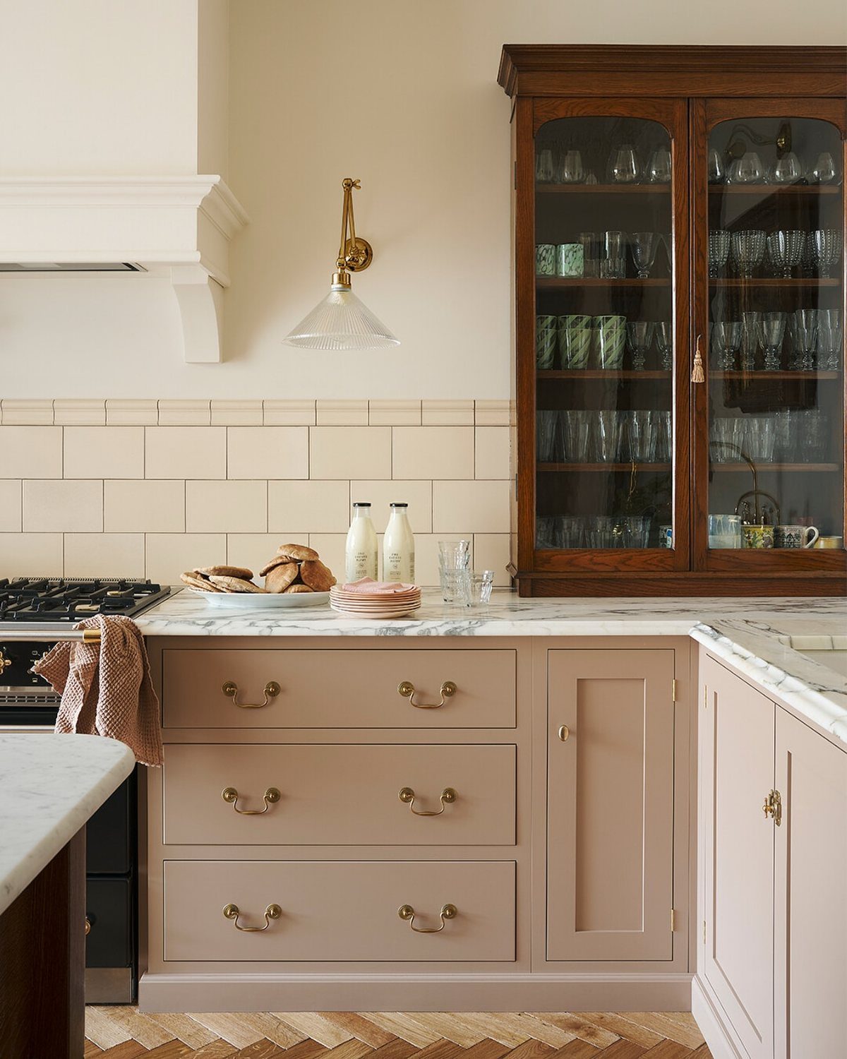 15 Ranch Style House Kitchen Remodel Ideas, Retro to Modern 14 Light pink kitchen cabinets with brass handles and a vintage dark wood hutch.