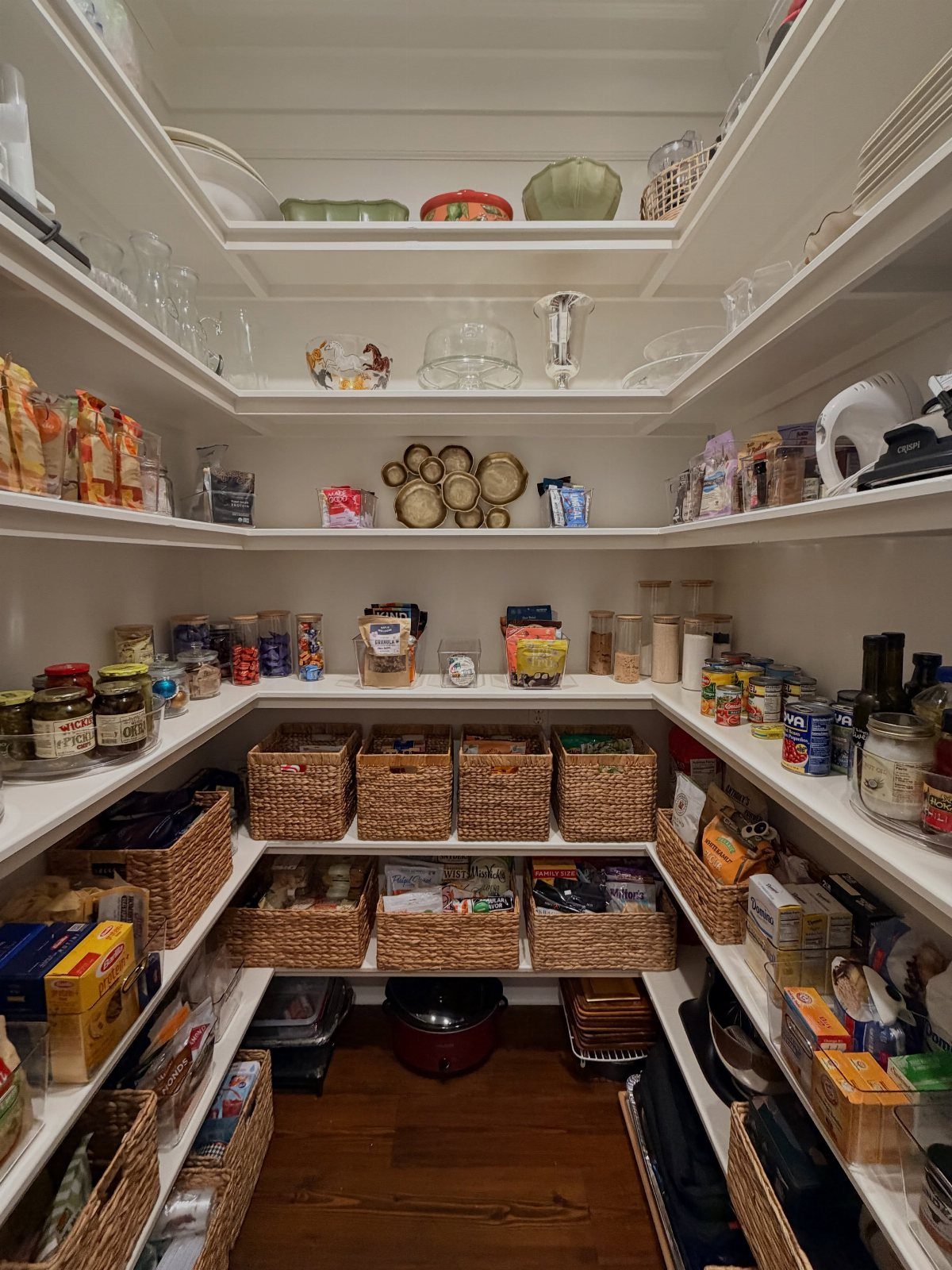 17 Remodeling Old House Ideas for Kitchens, Baths, Offices 17 Walk-in pantry with white shelving, woven baskets, and organized food and kitchenware.