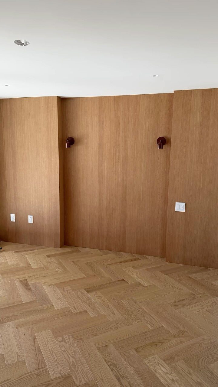 17 Remodeling Old House Ideas for Kitchens, Baths, Offices 13 Light wood paneled walls and herringbone parquet flooring in an empty room.