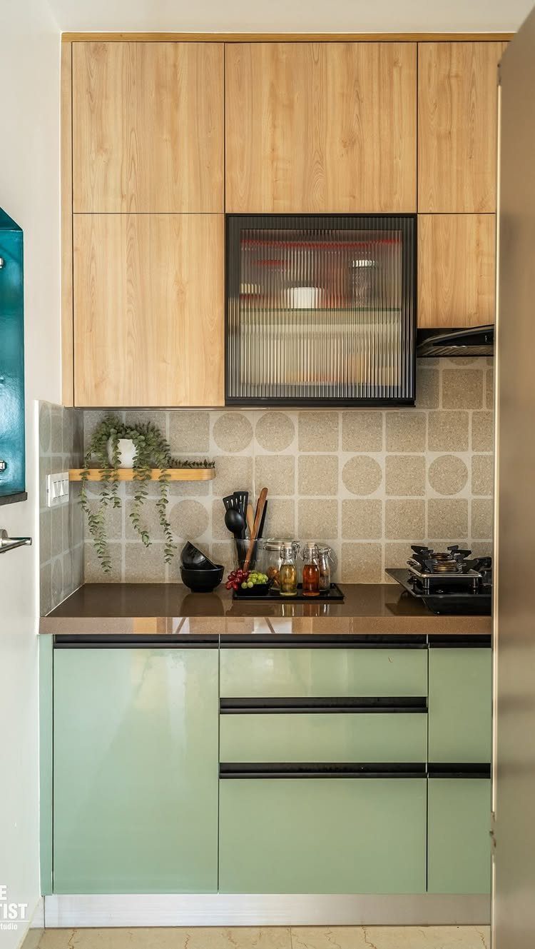 26 Sage Green Kitchen Ideas Using Wood, Brass, and Marble 25 Light sage green lower cabinets with light wood upper cabinets in a small kitchen.