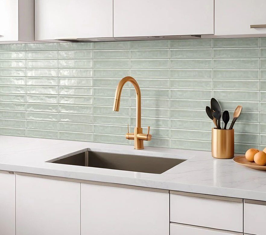 26 Sage Green Kitchen Ideas Using Wood, Brass, and Marble 13 Sage green tiled backsplash with a white countertop and gold kitchen faucet.