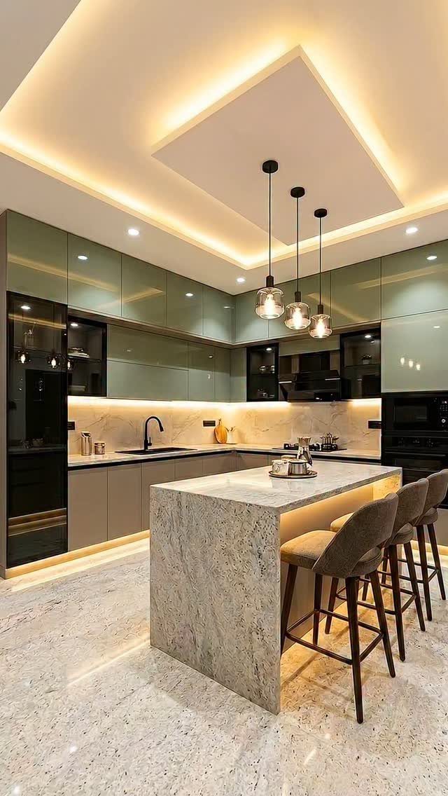 26 Sage Green Kitchen Ideas Using Wood, Brass, and Marble 14 Modern kitchen with sage green upper cabinets, gray lower cabinets, and marble island.