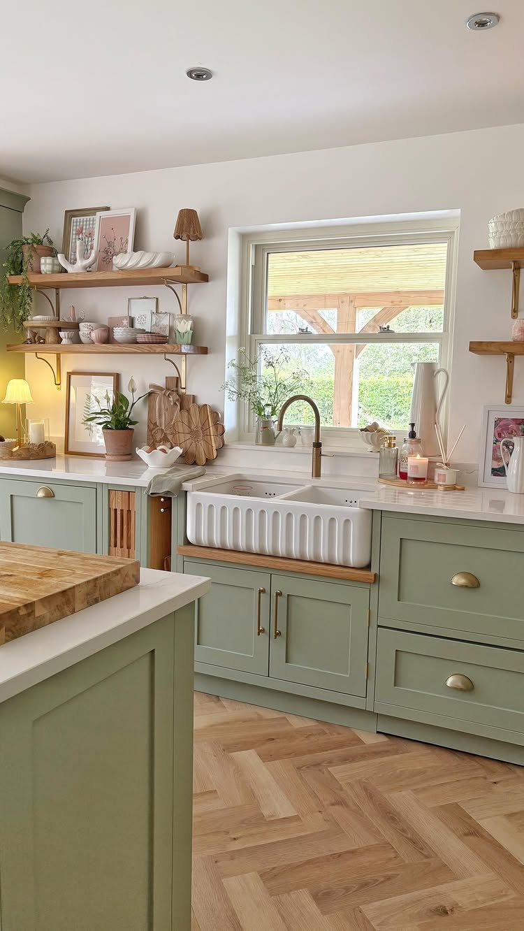 UK Kitchen Ideas Green: 21 Cabinet, Tile and Worktop Looks 13 Sage green shaker kitchen cabinets with a white farmhouse sink and herringbone wood flooring.