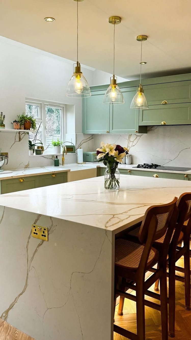 UK Kitchen Ideas Green: 21 Cabinet, Tile and Worktop Looks 14 Sage green kitchen cabinets with white marble countertops and gold pendant lighting.