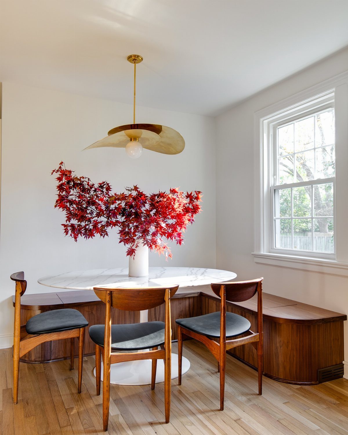 Vintage Kitchen Lighting Fixtures: 12 Pendant and Sconce Ideas 3 Brass tulip pendant light hanging over a marble table with mid-century modern chairs.